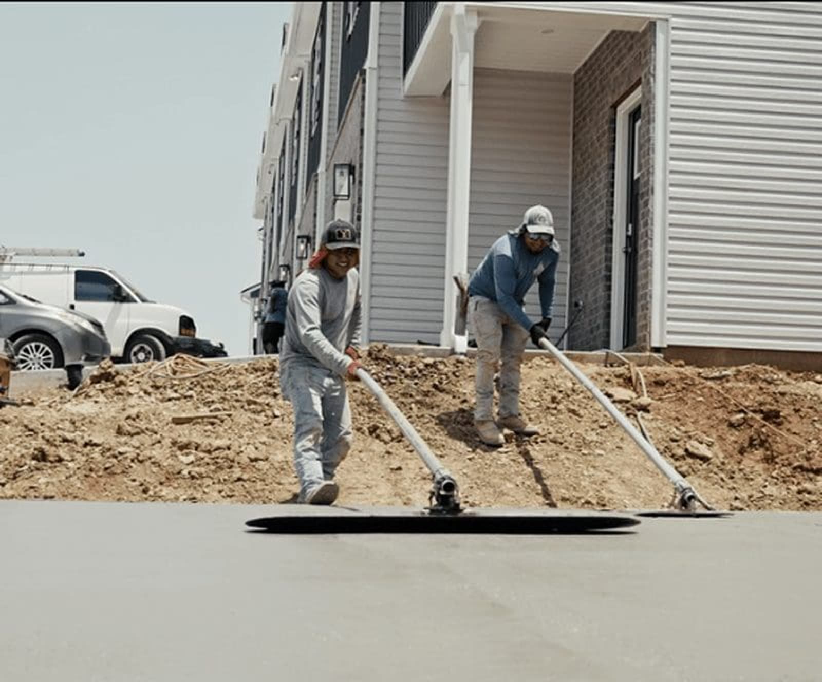 Cornerstone crew carefully finishing a concrete driveway